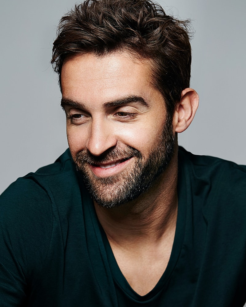 Smiling man with short hair and beard.